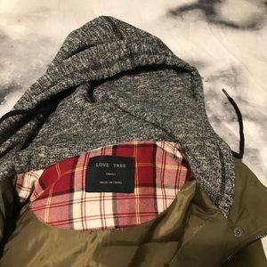 Army green color vest with a grey hoodie